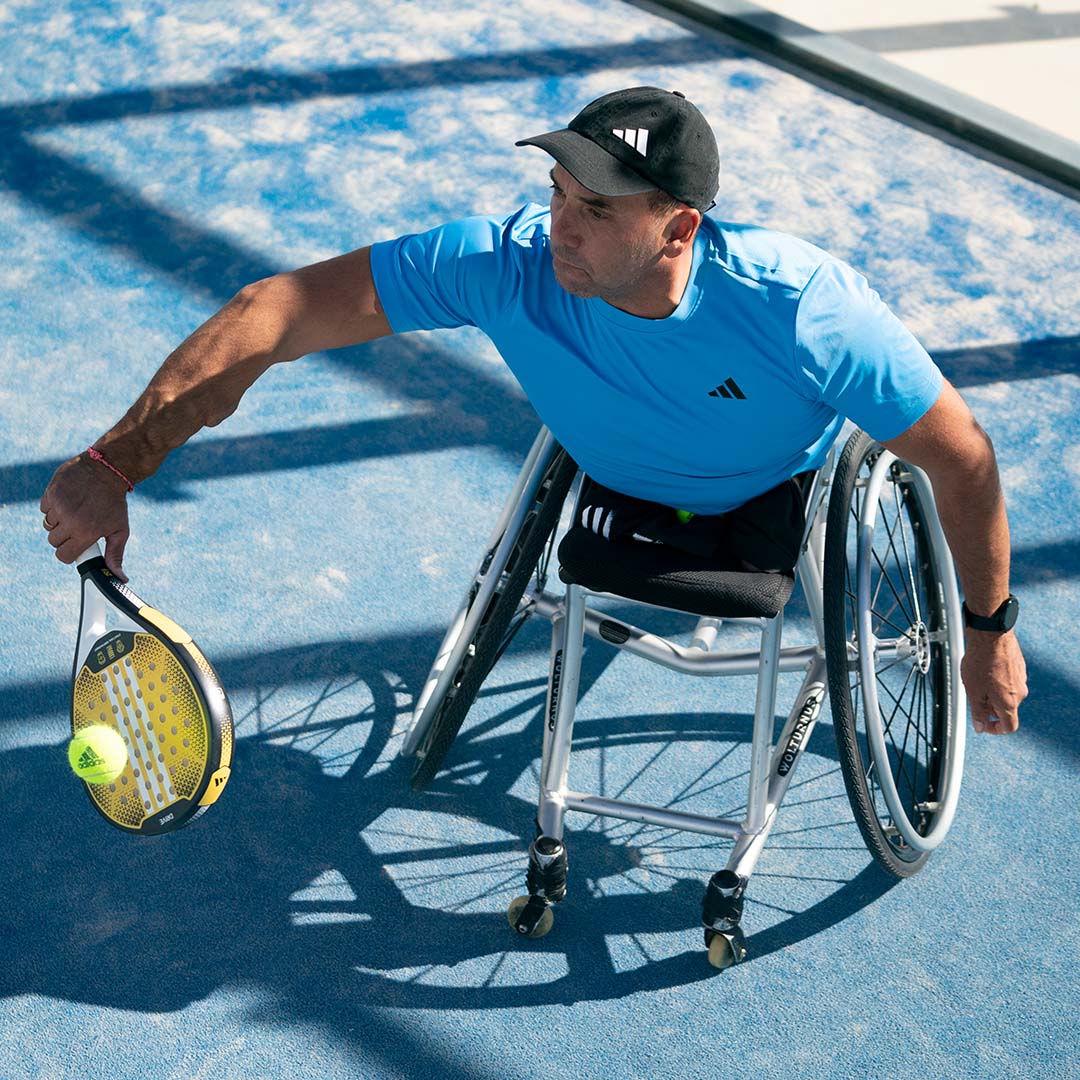 A disabled man playing padel with an adidas racquet