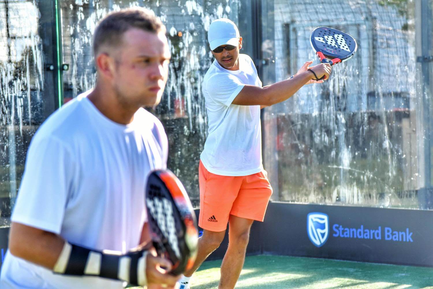 Men playing doubles padel with Adidas padel racquets