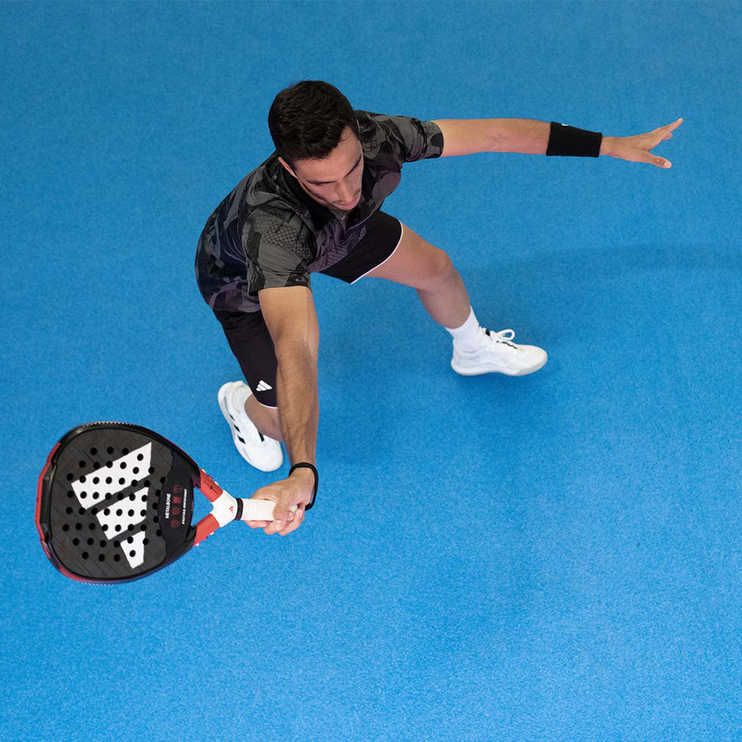 Man playing padel with an Adidas padel racquet