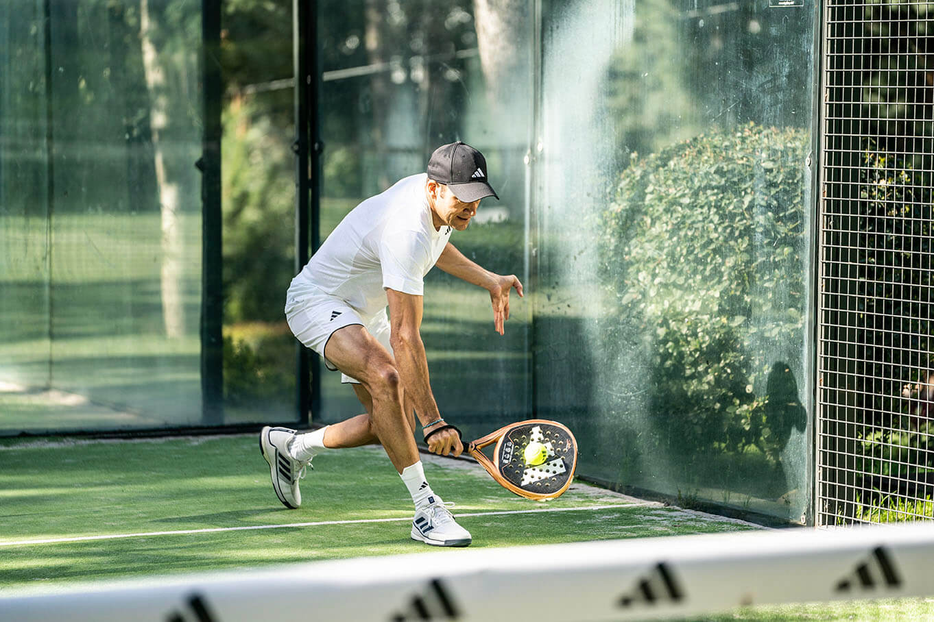 Man playing padel with Adidas racquet