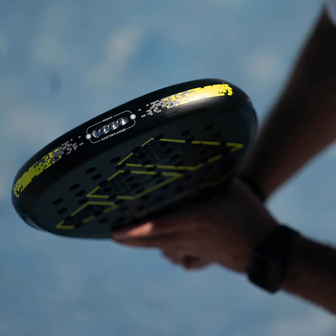 Man holding an Adidas padel racquet